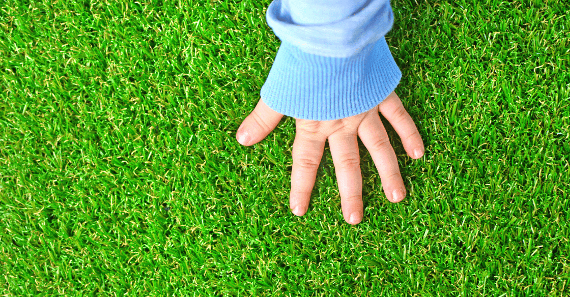 baby hand against grass