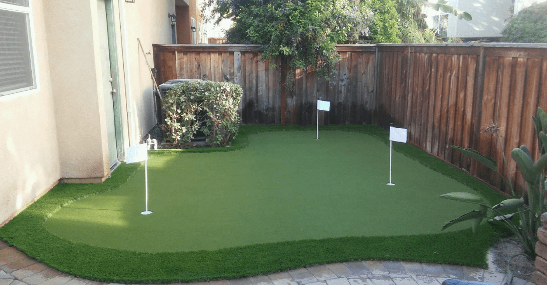 artificial turf putting green in a backyard